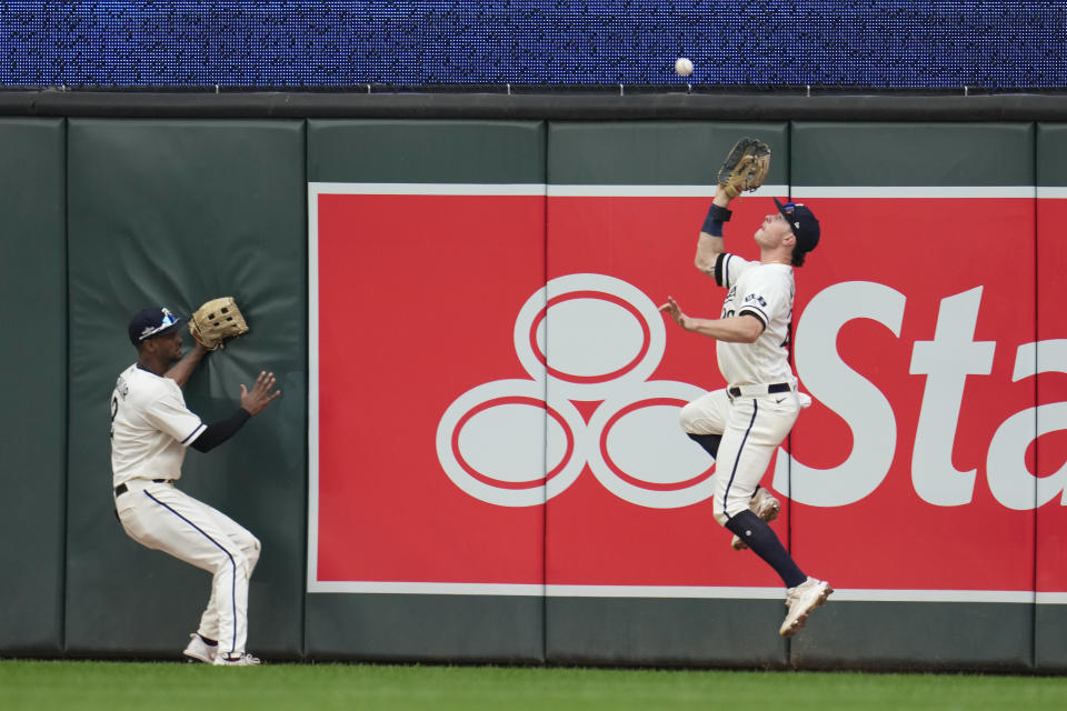 Minnesota Twins right fielder Max Kepler, right, makes a leaping catch on a fly ball from Toronto Blue Jays' Vladimir Guerrero Jr. during the fourth inning in Game 1 of an AL wild-card baseball playoff series Tuesday, Oct. 3, 2023, in Minneapolis. (AP Photo/Abbie Parr)