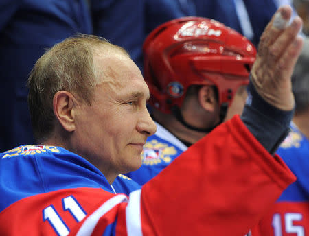 Russian President Vladimir Putin waves to the audience as he takes part in a gala game of the Night Ice Hockey League in Sochi, Russia, May 10, 2016. Sputnik/Kremlin via Reuters