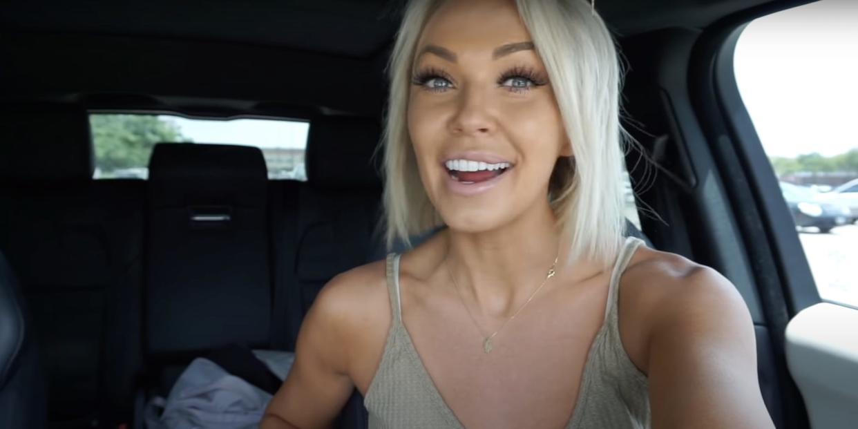 A screenshot of a YouTube by Brittany Dawn, showing her smiling and sitting in a car driving seat.