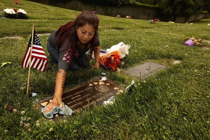 GLENDALE, CA - JUNE 7, 2017 - Darlene Guzman cleans her daughter Bree'Anna Jovette Guzman's gravesite at the Forest Lawn Memorial Park cemetery in Glendale on June 7, 2017. Jovette Guzman was killed six years ago. Geovanni Borjas, 32, was arrested on suspicion of murder and has been charged with two counts of murder, two counts of rape and one count of kidnapping. He is accused of killing 17-year-old Michelle Lozano and 22-year-old Bree'Anna Guzman. (Genaro Molina/Los Angeles Times)