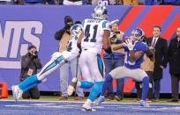 Dec 20, 2015; East Rutherford, NJ, USA; New York Giants wide receiver Odell Beckham (13) catches a touchdown pass against Carolina Panthers cornerback Josh Norman (24) with less than 2 minutes to play to tie the sore at MetLife Stadium. Mandatory Credit: Jim O'Connor-USA TODAY Sports