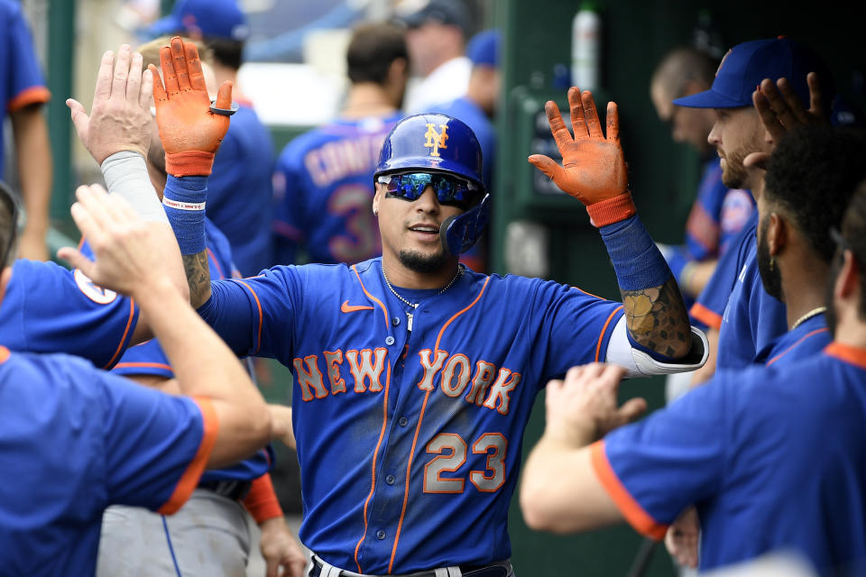 FILE - New York Mets' Javier Baez celebrates his home run in the dugout during the third inning of a baseball game against the Washington Nationals, Sunday, Sept. 5, 2021, in Washington. Javier Baez is nearing a $140 million, six-year contract with Detroit, giving the Tigers a dynamic bat for the middle of their order. Baez, who turns 29 on Wednesday, hit .265 with 31 homers and 87 RBIs in 138 games with the Cubs and Mets last season. A person with direct knowledge of the situation confirmed the deal to The Associated Press on Tuesday, Nov. 30, on condition of anonymity because the contract had not been finalized. (AP Photo/Nick Wass, File)