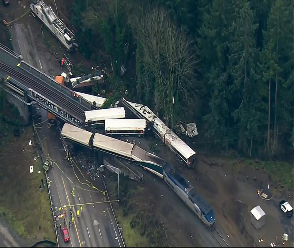 <p>This aerial image from video provided by KOMO-TV, shows the site of an Amtrak train that derailed south of Seattle on Monday, Dec. 18, 2017. Authorities reported “injuries and casualties.” The train derailed about 40 miles (64 kilometers) south of Seattle before 8 a.m., spilling at least one train car on to busy Interstate 5. (Photo: KOMO-TV via AP) </p>