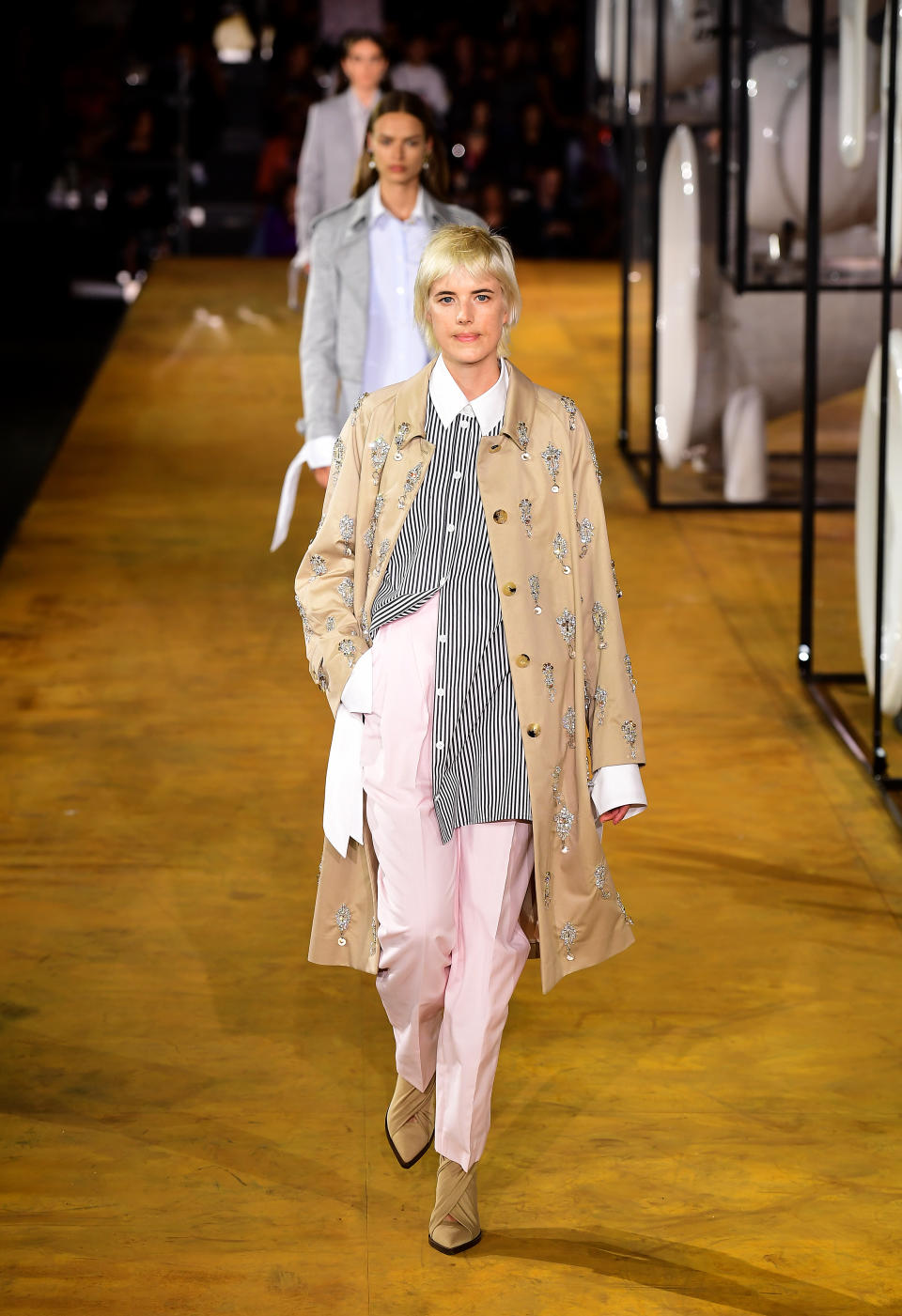 Agyness Deyn walked the catwalk in pink trousers, a striped skirt and trench coat. [Photo: PA]