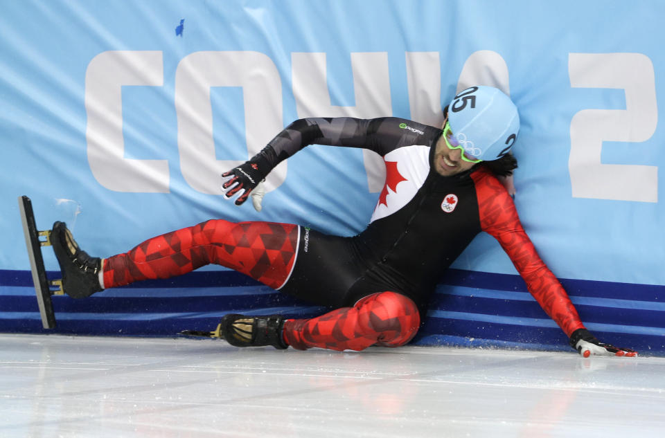 Charles Hamelin of Canada crashes out in a men's 500m short track speedskating heat at the Iceberg Skating Palace during the 2014 Winter Olympics, Tuesday, Feb. 18, 2014, in Sochi, Russia.