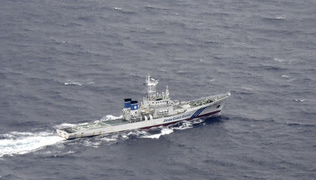 A Japan Coast Guard patrol vessel sails on the water at the area where two U.S. Marine Corps aircraft have been involved in a mishap in the skies, off the coast of Kochi prefecture, Japan, in this aerial view photo taken by Kyodo December 6, 2018. Mandatory credit Kyodo/via REUTERS