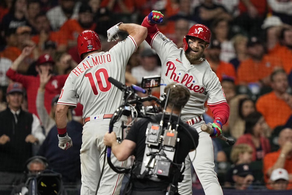 Philadelphia Phillies' J.T. Realmuto celebrates his home run during the 10th inning in Game 1 of baseball's World Series between the Houston Astros and the Philadelphia Phillies on Friday, Oct. 28, 2022, in Houston. (AP Photo/David J. Phillip)