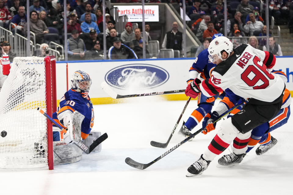 New York Islanders goaltender Ilya Sorokin (30) stops a shot on goal by New Jersey Devils' Timo Meier (96) during the first period of an NHL hockey game Monday, March 27, 2023, in Elmont, N.Y. (AP Photo/Frank Franklin II)