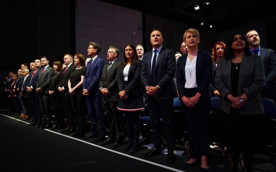 Yvette Cooper (pictured second from the right) and other shadow Cabinet members stand to sing the National Anthem on the first day of Labour's annual conference in Liverpool  - Ian Forsyth/Getty Images Europe