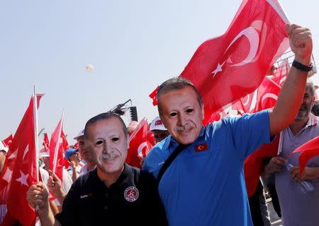 People wear masks depicting Turkish President Tayyip Erdogan during the Democracy and Martyrs Rally, organized by him and supported by ruling AK Party (AKP), oppositions Republican People's Party (CHP) and Nationalist Movement Party (MHP), to protest against last month's failed military coup attempt, in Istanbul, Turkey, August 7, 2016. REUTERS/Umit Bektas