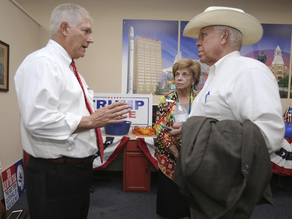 Former US Rep. Pete Sessions, left, speaks Jon R. Ker Chairman, McLennan County Republican Party and supporter Barbara Kent Thursday, Oct. 3, 2019, in Waco, Texas as he runs to fill the seat of Bill Flores who is stepping down Jon R. Ker Chairman, McLennan County Republican Party. (Jerry Larson/Waco Tribune-Herald via AP)