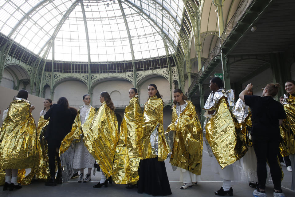 Models wait before the presentation of Chanel Haute Couture Spring/Summer 2020 fashion collection, Tuesday Jan.21, 2020 in Paris. (AP Photo/Thibault Camus)