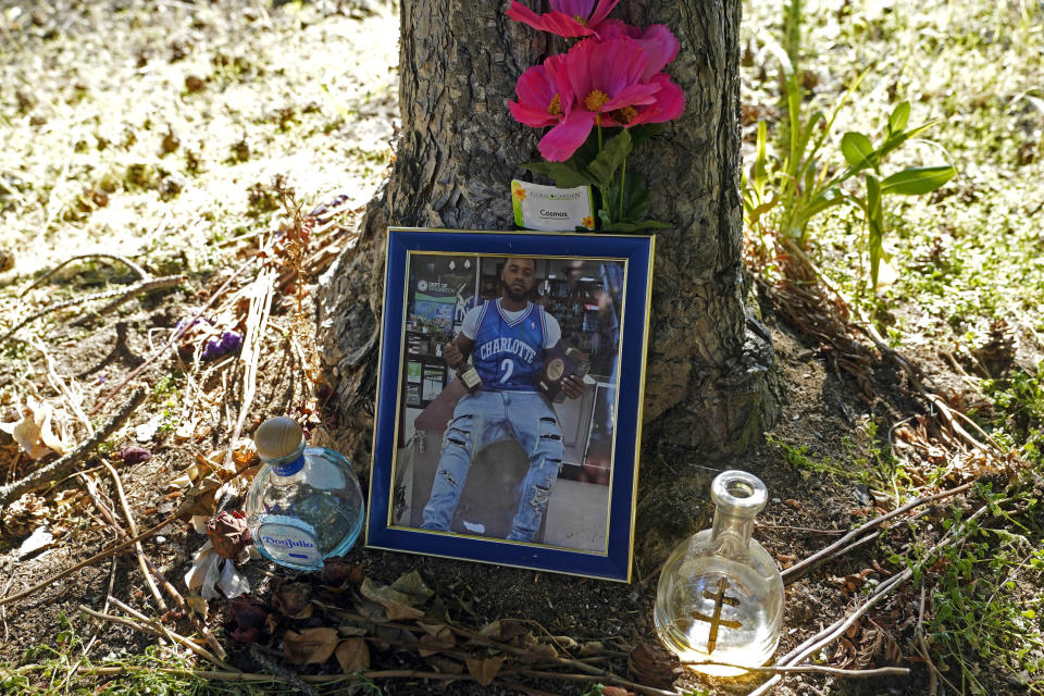 A memorial for Christopher Roberts Jr., who was killed in a 2020 shooting in the parking lot of a Safeway store in Seattle's Rainier Beach neighborhood, is shown Tuesday, July 12, 2022 near where the shooting took place. The space is now where a community group holds weekly gatherings to provide food, referrals to services and "healing spaces" for people affected by violence, work that falls under the umbrella of strategies known as community violence intervention, an approach backed by the Biden administration and donations from several major philanthropic foundations, which tries to stop local conflicts from escalating. (AP Photo/Ted S. Warren)