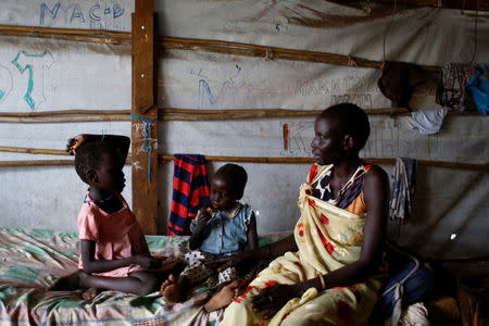 Nyagonga Machul, 38 converses with her daughters Nyameer Mario, 6 (L) and Nyawan Mario, 4, in their home at the United Nations Mission in South Sudan (UNMISS) Protection of Civilian site (CoP) in Juba, South Sudan, February 15, 2017. REUTERS/Siegfried Modola