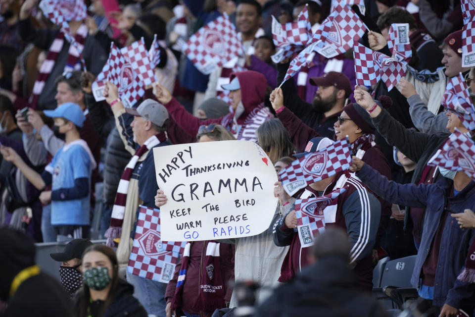 Colorado Rapids fans welcome their team to the pitch to face the Portland Timbers in an MLS Western Conference semifinal playoff soccer match Thursday, Nov. 25, 2021, in Commerce City, Colo. (AP Photo/David Zalubowski)