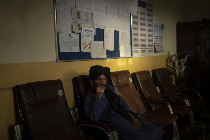 Twenty-two-year-old Taliban member Mohammad Javid Ahmadi sits inside an office in the hospital in Mirbacha Kot, Afghanistan on Tuesday, Oct. 26, 2021. Ahmadi, who has no medical training or experience, was appointed as the new manager of the hospital. (AP Photo/Bram Janssen)