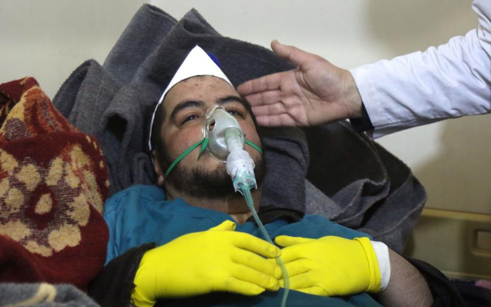 A Syrian man receives treatment following a suspected toxic gas attack in April - Credit: AFP