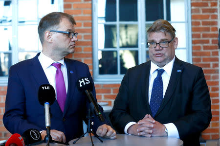 Finland's Prime Minister Juha Sipila (L) listens to Foreign Minister Timo Soini after government's open session for members of public took place during the celebration of the 100th anniversary of Finnish independence in Porvoo, Finland May 4, 2017. REUTERS/Ints Kalnins