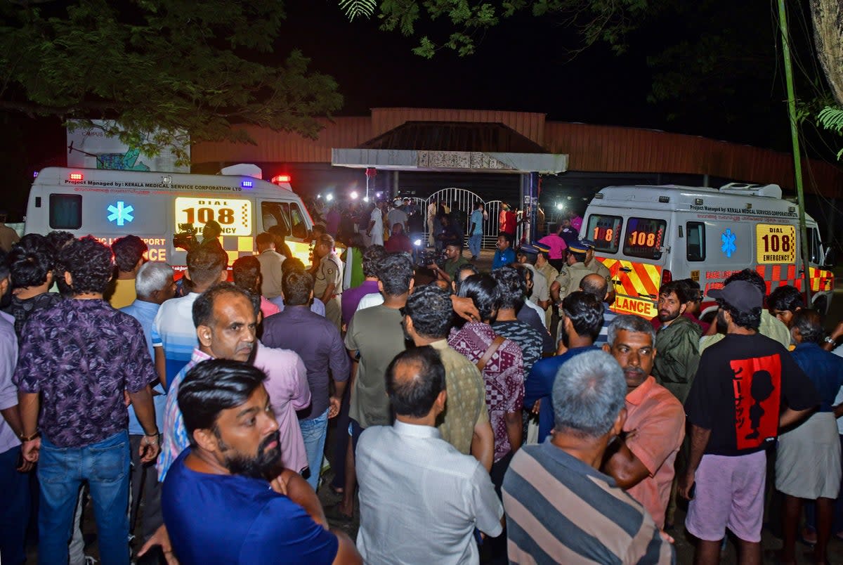 People gather outside after a stampede at the venue of a music concert at the Cochin University  (AP)