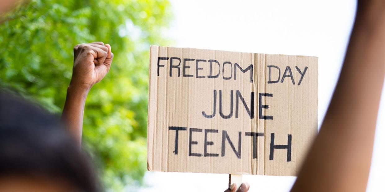 concept of juneteenth freedom day march showing by close up protesting hands sign board concept of activism, justice and demonstration