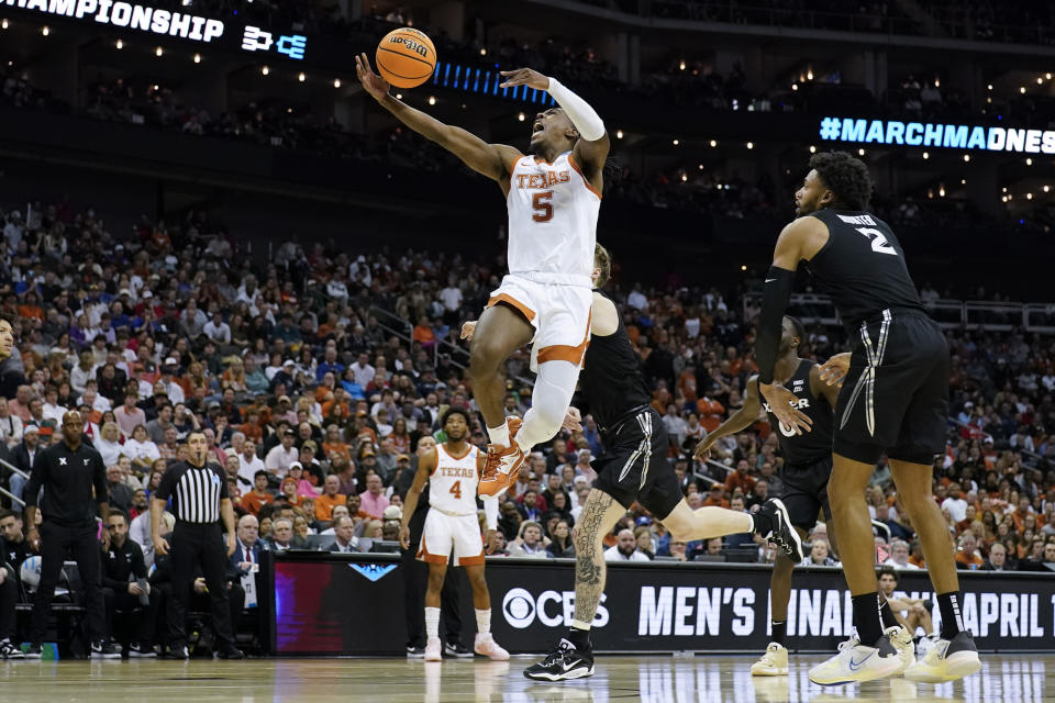 Texas guard Marcus Carr scores past Xavier forward Jerome Hunter in the first half of a Sweet 16 college basketball game in the Midwest Regional of the NCAA Tournament Friday, March 24, 2023, in Kansas City, Mo. (AP Photo/Jeff Roberson)