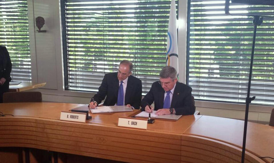 In this photo released by Patrick Sandusky of the United States Olympic Committee, International Olympic Committee (IOC) President Tomas Bach, right, and Chairman and CEO of Comcast Corporation Brian L. Roberts sign an agreement to secure the U.S. broadcast rights to the Olympics through to 2032 for NBC Universal, in Lausanne, Switzerland, Wednesday, May 7, 2014. NBC secured the U.S. broadcast rights to the Olympics through 2032 on Wednesday in a record six-games deal worth $7.75 billion. NBC already holds the rights through the 2020 Olympics in a four-games deal signed in 2011 for $4.38 billion. (AP Photo/Patrick Sandusky, USOC)