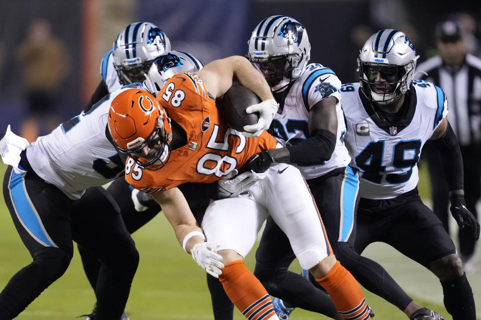 Chicago Bears tight end Cole Kmet (85) is tackled by a group of Carolina Panthers defenders after a catch during the first half of an NFL football game Thursday, Nov. 9, 2023, in Chicago. (AP Photo/Charles Rex Arbogast)