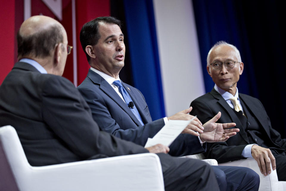 Scott Walker, governor of Wisconsin, center, Louis Woo, special assistant to the chairman of Foxconn Technology Group, right, and Wilbur Ross, U.S. commerce secretary, speaks at a panel at the SelectUSA Investment Summit on June 21, 2018. (Andrew Harrer/Bloomberg)