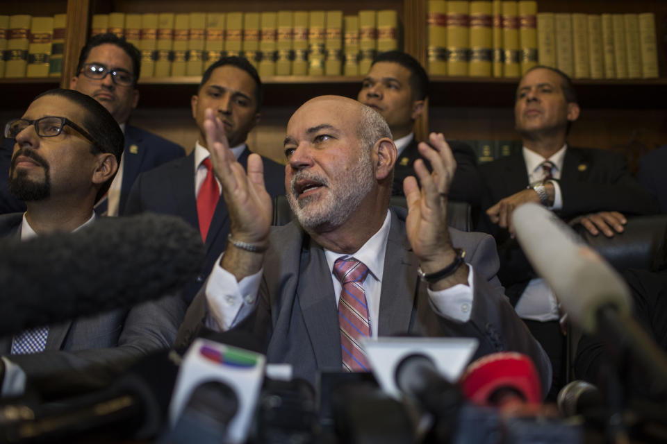 House leader Carlos Mendez Nunez speaks during a press conference regarding the nomination process for the next secretary of state, in San Juan, Puerto Rico, Thursday, Aug. 1, 2019. Puerto Rican politics were in full-blown crisis Thursday as confirmation of the nominee to succeed departing Gov. Ricardo Rossello was delayed into next week, casting doubt over who will become governor when Rossello leaves office tomorrow. (AP Photo/Dennis M. Rivera Pichardo)