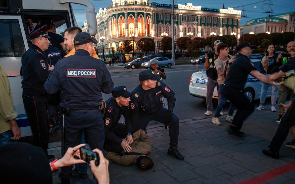Police detain demonstrators during a protest against mobilisation in Yekaterinburg in Russia - AP