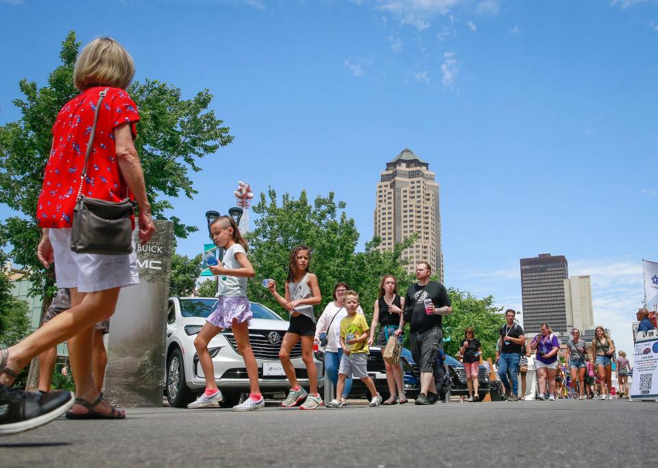 Art lovers walk along Locust Street during the 2022 Des Moines Arts Festival in downtown Des Moines.