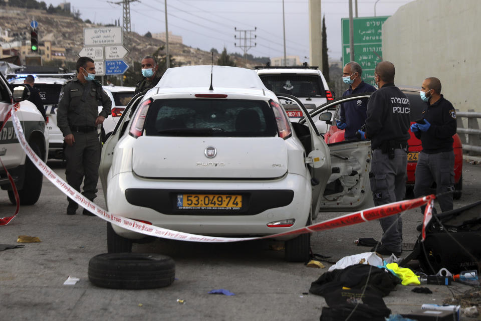 Israeli police inspect the scene of what they say was an attempted car-ramming attack at a West Bank checkpoint near Jerusalem, Wednesday, Nov. 25, 2020. Israeli forces shot and killed the Palestinian motorist who police said tried to ram his car into a soldier at the checkpoint. (AP Photo/Mahmoud Illean)