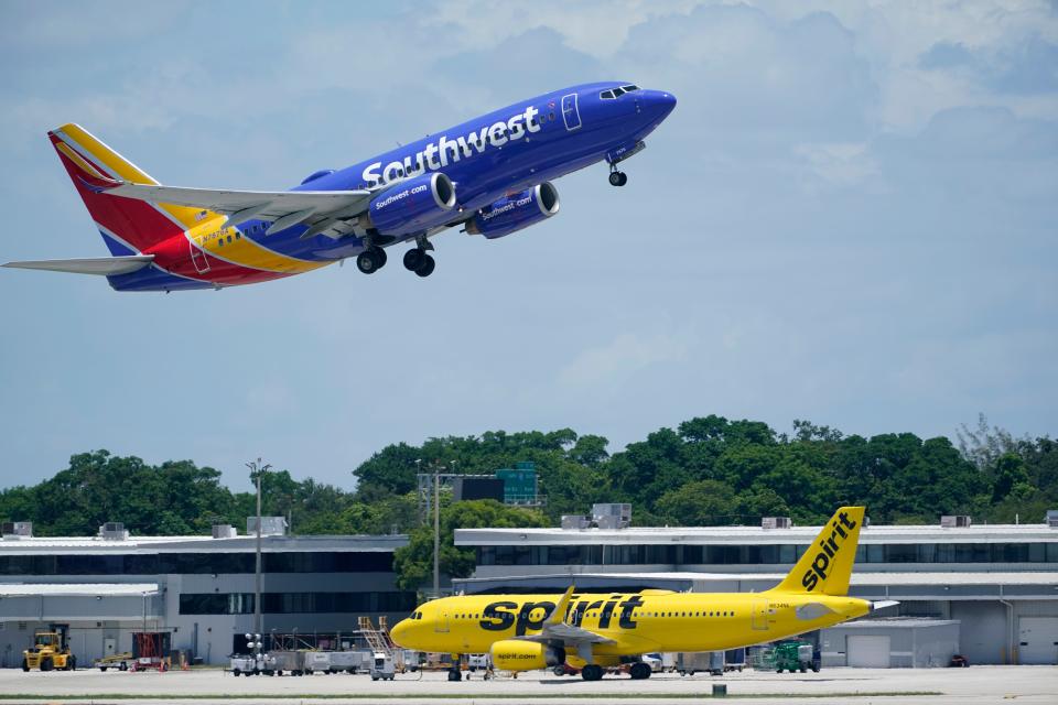 A Southwest Airlines Boeing 737, passes a Spirit Airlines Airbus A320 as it takes off, Thursday, July 7, 2022, at the Fort Lauderdale-Hollywood International Airport in Fort Lauderdale, Fla. (AP Photo/Wilfredo Lee) ORG XMIT: FLWL215