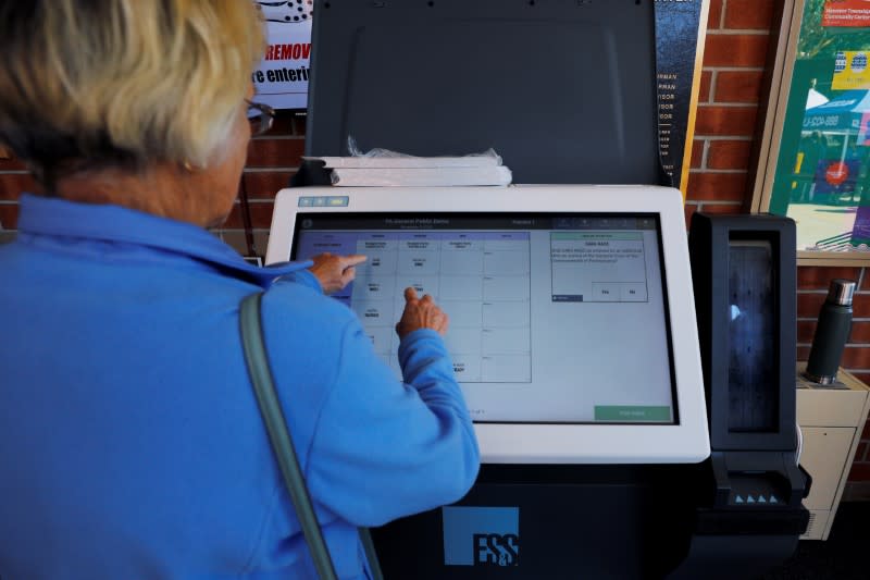 FILE PHOTO: Kathy Konrad casts his vote on a new Election Systems & Software ExpressVote XL voting machine in Hanover Township