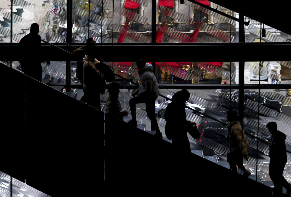 FILE - Shoppers walk up and down the stairs in a Nike store on Black Friday, Nov. 25, 2022, in New York. Mistakes during the holiday season can be detrimental to a business’s bottom line — but small-business owners still have time to put themselves in the best position for success. To avoid common holiday mistakes, business owners should plan ahead and use historical data to anticipate their seasonal needs. (AP Photo/Julia Nikhinson, File)