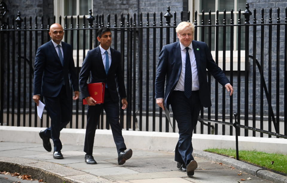 British Health Secretary Sajid David, Chancellor of the Exchequer Rishi Sunak and Prime Minister Boris Johnson arrive for a news conference in Downing Street in September 2021. All three have resigned this week.