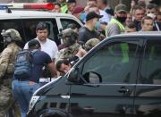 Members of a Ukrainian special forces unit detain a man who threatened to blow up a bomb in a bank branch, in Kyiv