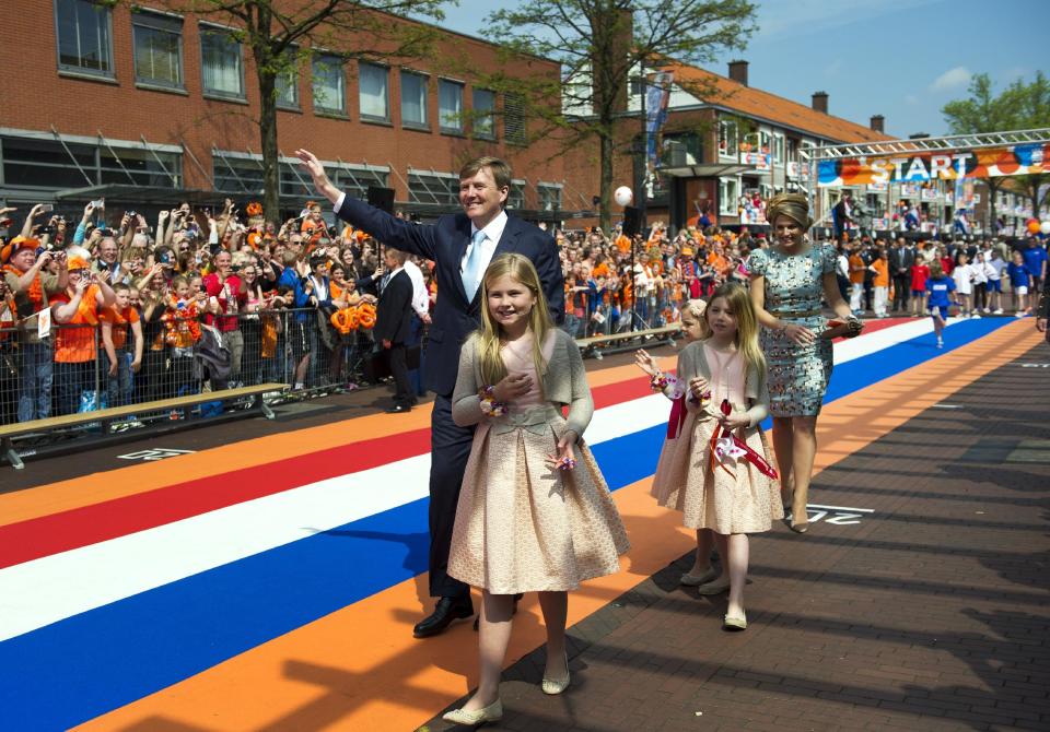 Netherlands' King Willem Alexander, and Queen Maxima walk with their children during festivities marking King's Day in Amstelveen, near Amsterdam, Netherlands, Saturday, April 26, 2014. The Dutch marked King's Day on Saturday, a national holiday held in honor of the newly installed monarch, King Willem Alexander. King's Day replaces the traditional Queen's Day. (AP Photo/Patrick Post)
