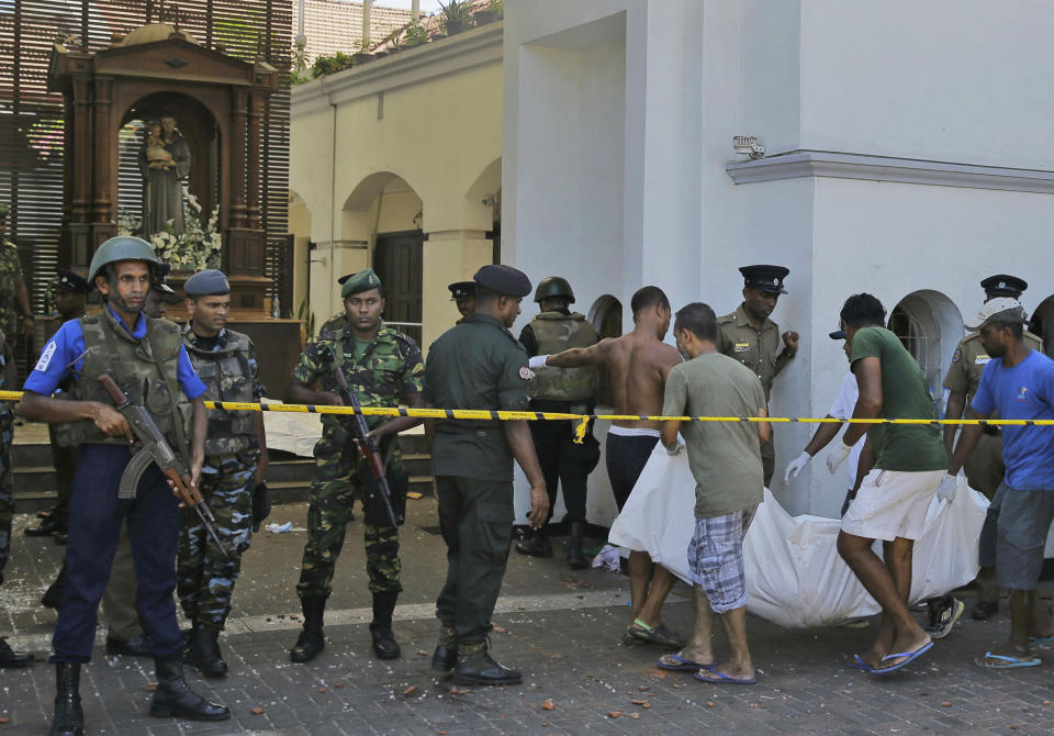 Sri Lankans carry a dead body following a blast at the St. Anthony's Church in Colombo, Sri Lanka on April 21, 2019. (Photo: Eranga Jayawardena/AP)