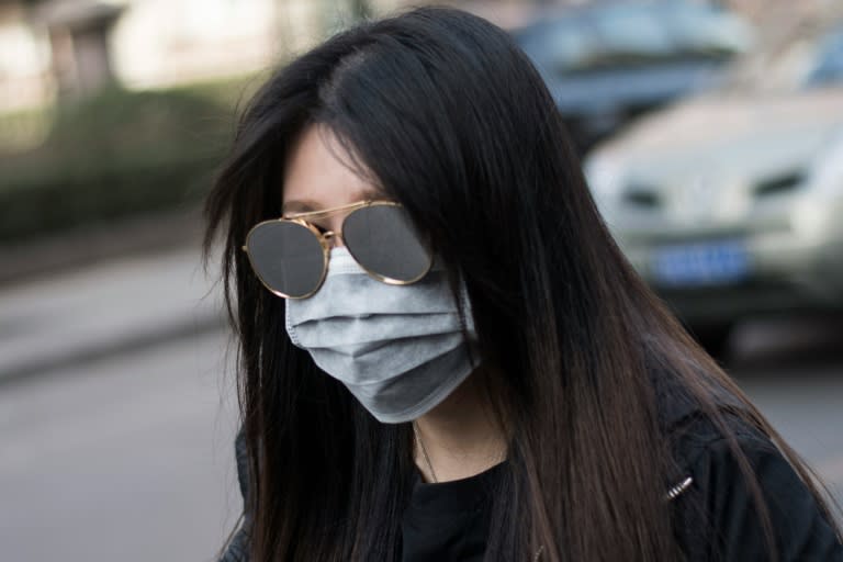 A woman wearing a face mask during a yellow alert for air pollution in Beijing on March 18, 2016