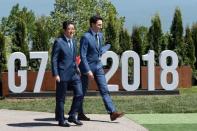 Canada's Prime Minister Justin Trudeau and Japanese Prime Minister Shinzo Abe arrive for a family photo at the G7 Summit in the Charlevoix city of La Malbaie, Quebec, Canada, June 8, 2018. REUTERS/Yves Herman