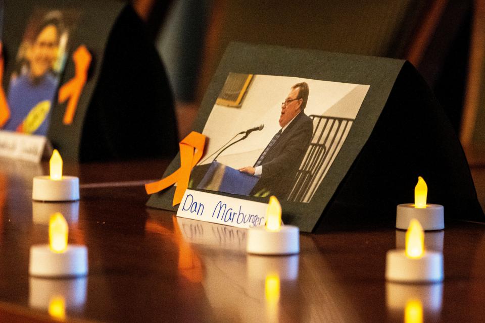Flameless candles flicker in front of a picture of Perry High School prinicpal Dan Marburger, who died after being shot on Jan. 4, during a March for Our Lives vigil for gun violence victims at the Iowa State Capitol on Saturday, Jan. 27, 2024, in Des Moines.