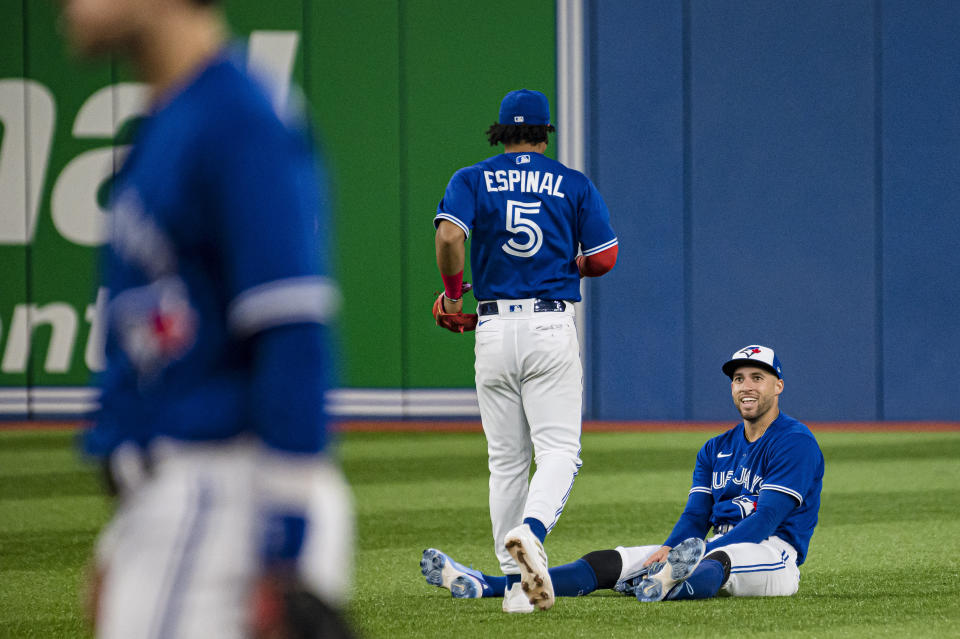 Toronto Blue Jays center fielder George Springer sits on the field after catching a ball hit by Boston Red Sox's J.D. Martinez during the sixth inning of a baseball game Wednesday, June 29, 2022, in Toronto. (Christopher Katsarov/The Canadian Press via AP)