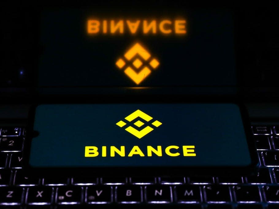 Binance logo is displayed on a mobile phone screen