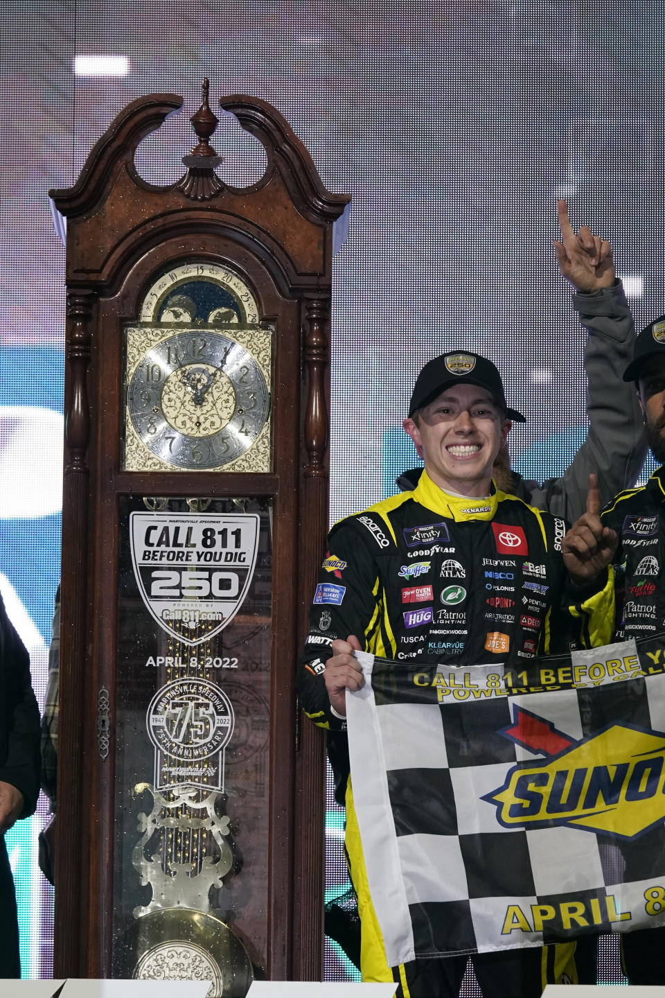 Brandon Jones stands next to the trophy after his win in the NASCAR Xfinity Series auto race at Martinsville Speedway on Friday, April 8, 2022, in Martinsville, Va. (AP Photo/Steve Helber)