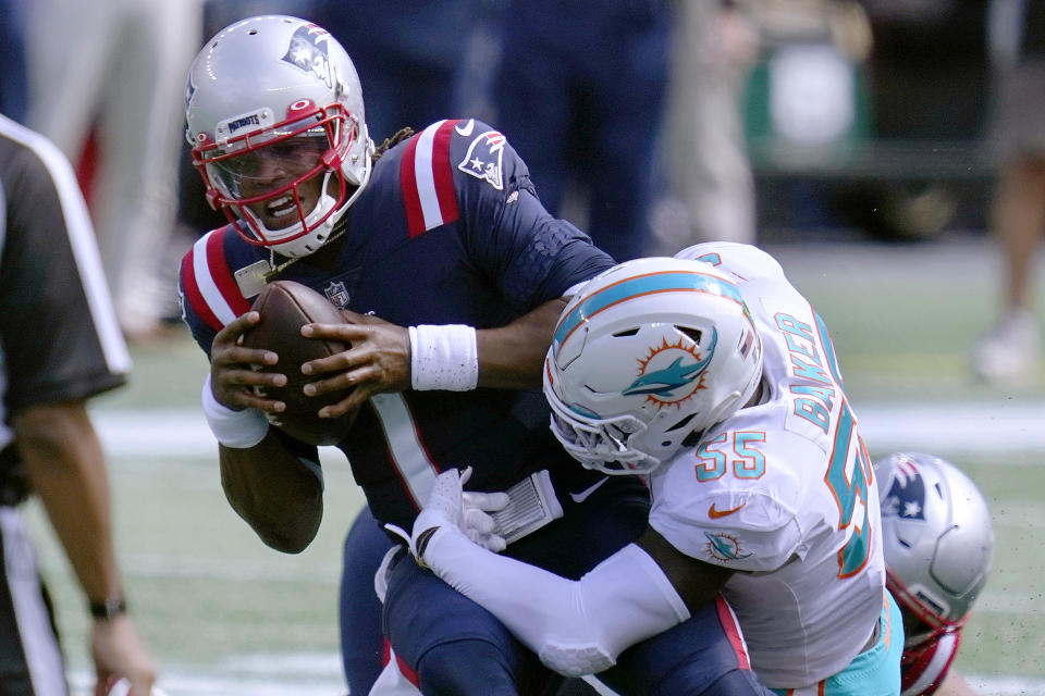 Miami Dolphins linebacker Jerome Baker (55) tackles New England Patriots quarterback Cam Newton (1) in the first half of an NFL football game, Sunday, Sept. 13, 2020, in Foxborough, Mass. (AP Photo/Charles Krupa)