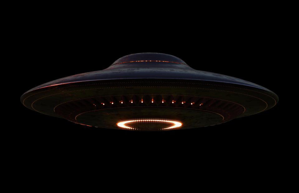 Illustration of a UFO with illuminated circular patterns on its underside against a dark background