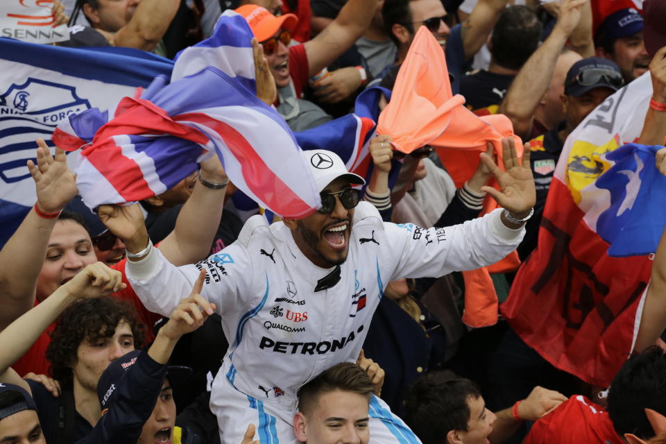 A fan dressed as Mercedes driver Lewis Hamilton, of Britain, cheers after the Brazilian Formula One Grand Prix at the Interlagos race track in Sao Paulo, Brazil, Sunday, Nov. 11, 2018. Five-time world champion Lewis Hamilton won the race helping his team to take the constructors' title. (AP Photo/Nelson Antoine)