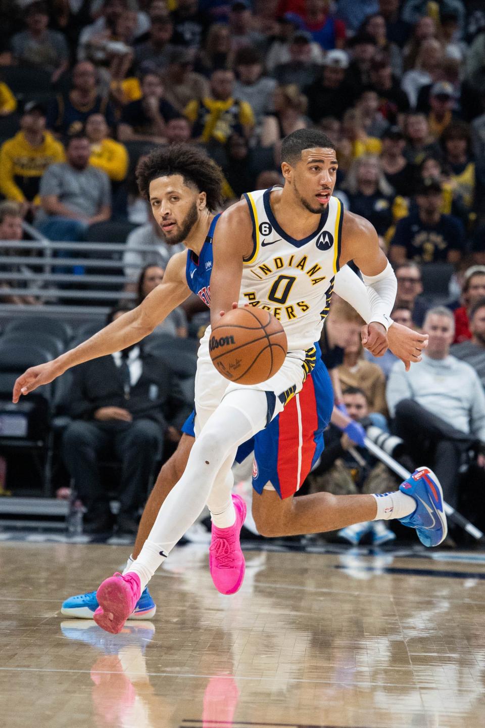 Pacers guard Tyrese Haliburton (0) dribbles the ball while Pistons guard Cade Cunningham defends in the second half Oct. 22, 2022 at Gainbridge Fieldhouse in Indianapolis.