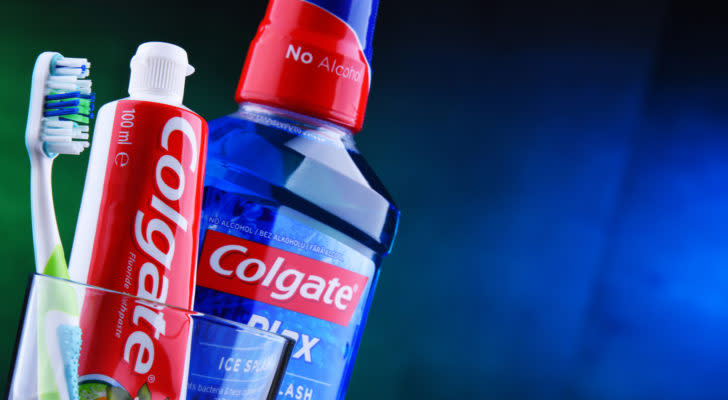 Colgate toothpaste and mouthwash in a cup with a toothbrush